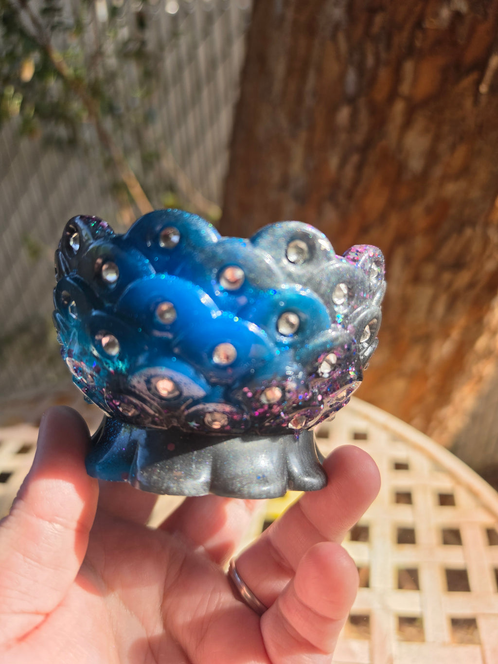 Side view of galaxy resin bowl showing rhinestone-studded scalloped edge and purple glitter detail
