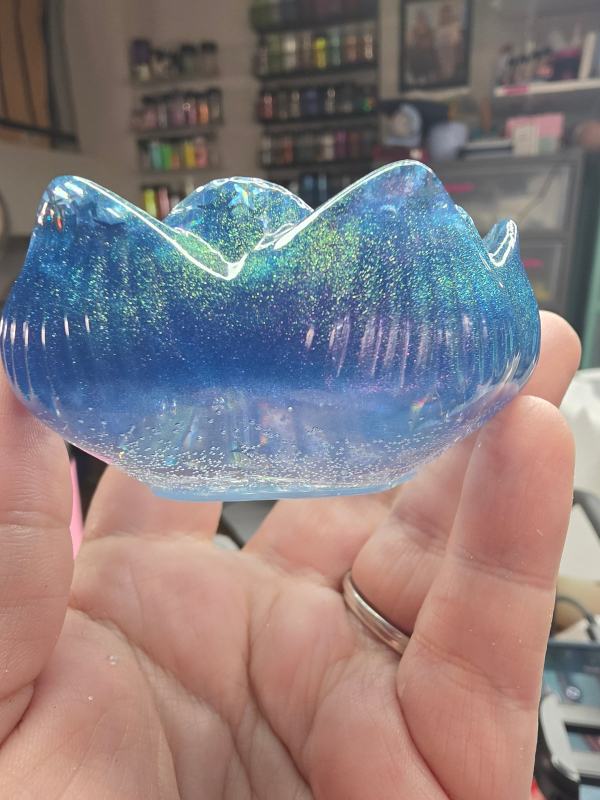 Side view of blue-to-purple galaxy lotus resin dice throne showing scalloped petal rim and shimmer glitter