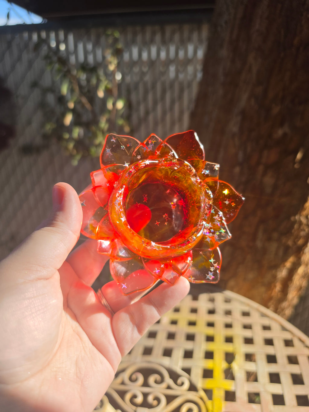 Close-up of lotus resin dice throne interior bowl showing iridescent star glitter and red resin depth