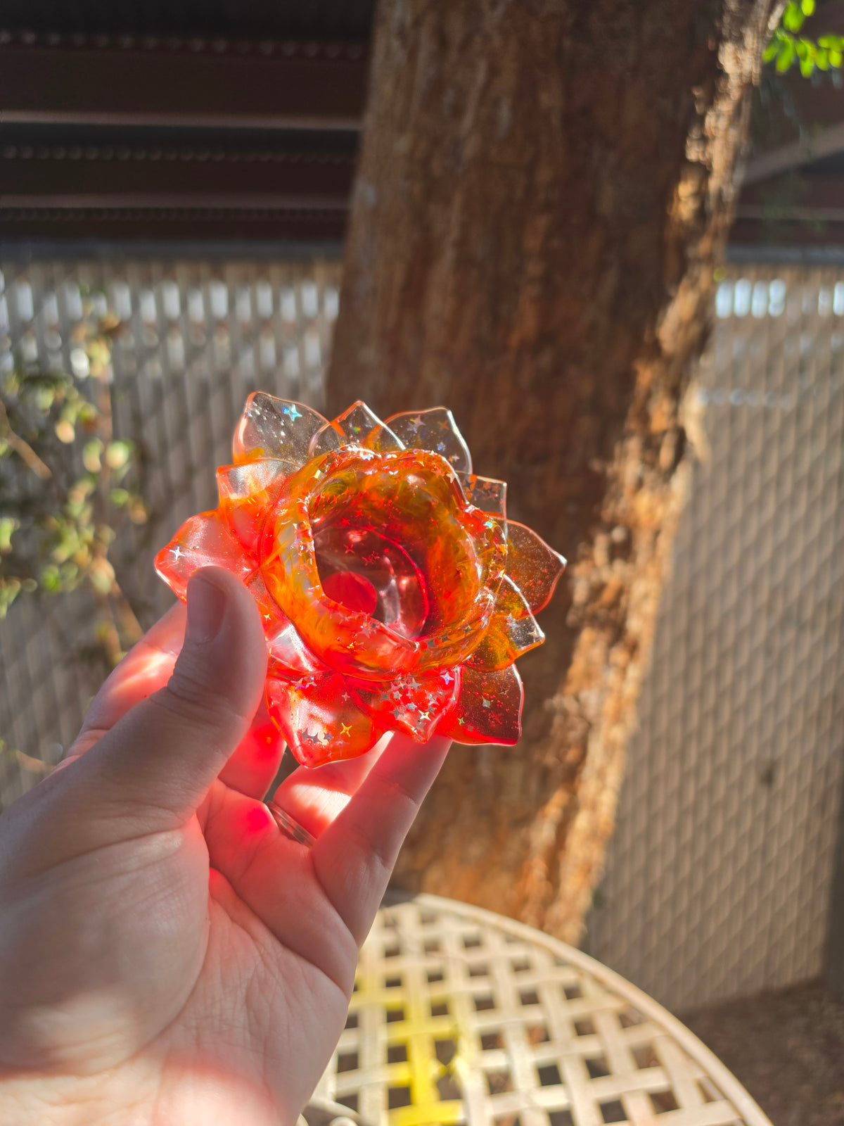 Top-down view of red resin lotus throne showing deep center bowl with iridescent star glitter