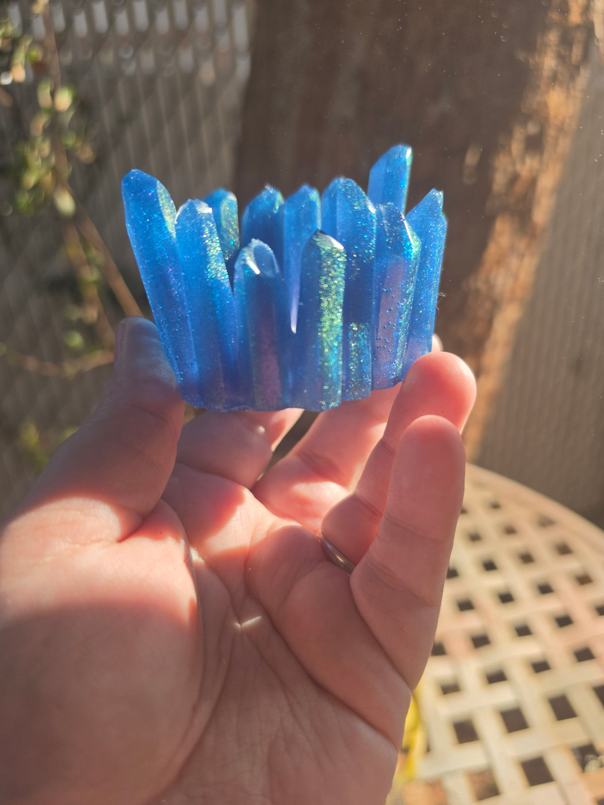 Angled view of blue resin crystal throne showing full cluster of spires and hollow center bowl