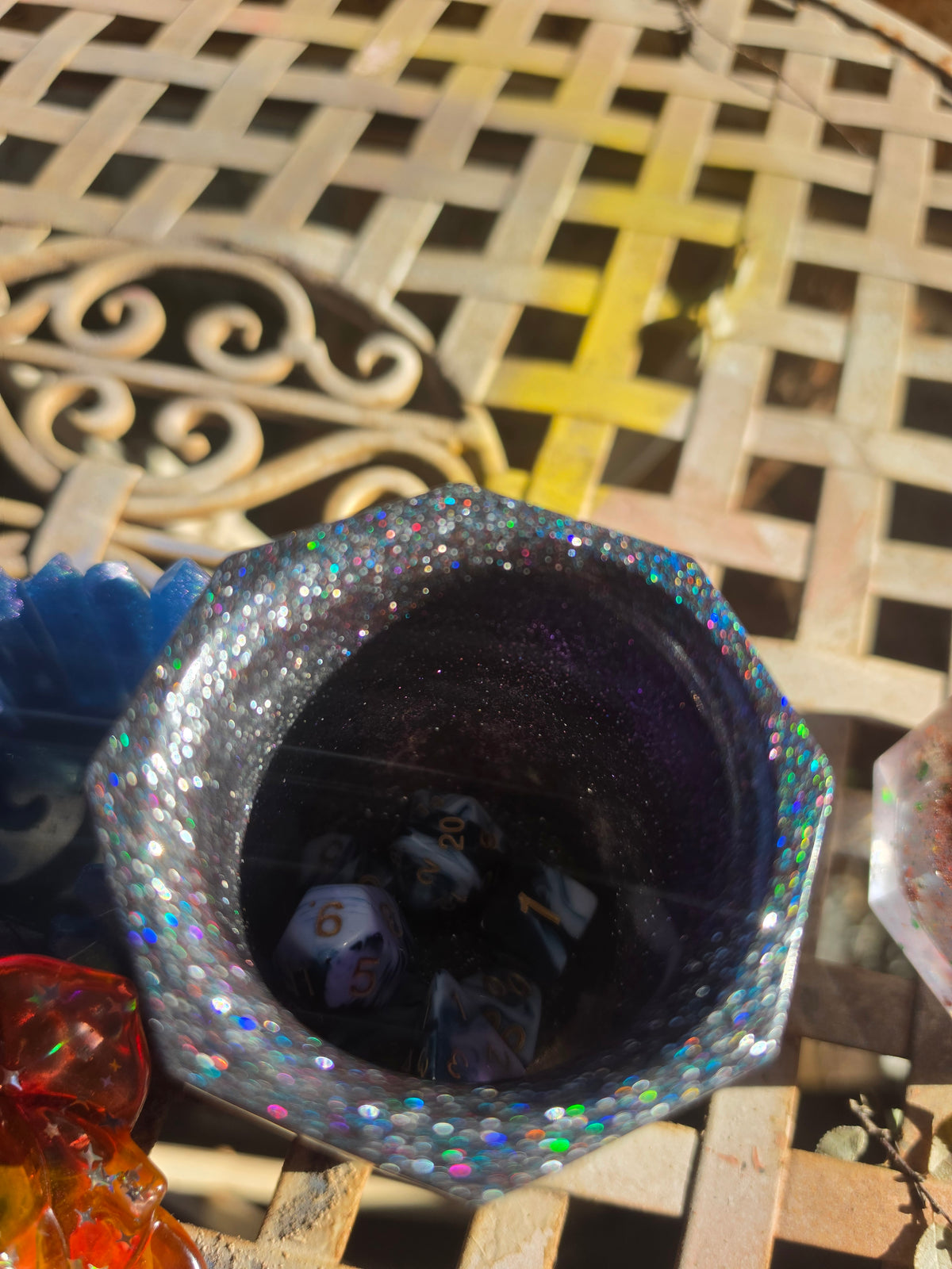 Top-down view of midnight galaxy resin dice cup showing holographic glitter rim and deep purple interior with dice inside