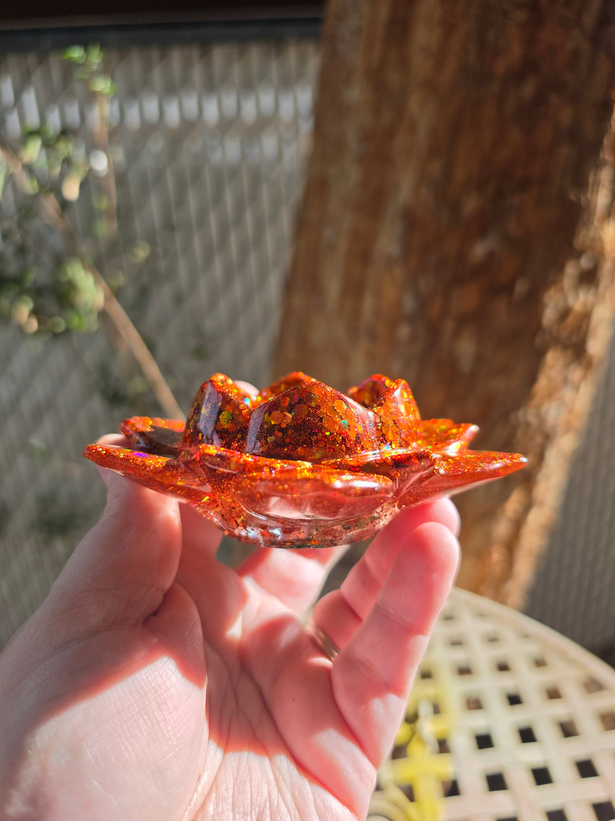 Side profile of lotus resin tealight holder showing two tiers of ruffled petals