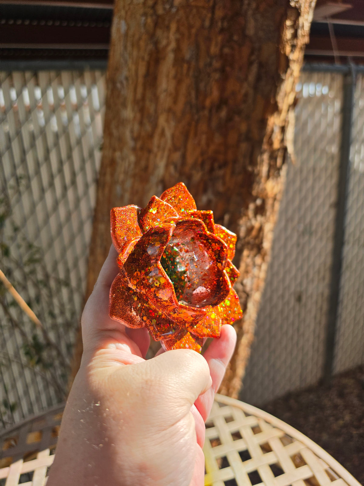 Autumn lotus resin throne in sunlight showing warm amber and copper tones with glitter sparkle