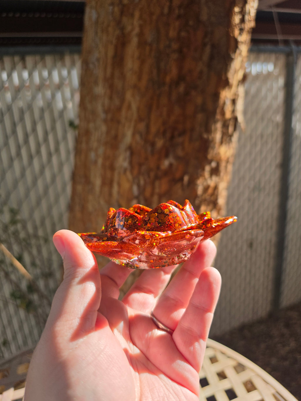 Angled view of autumn lotus resin dice throne showing full petal detail and warm orange hues