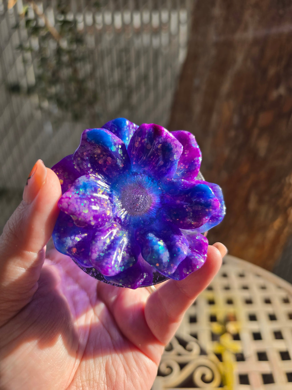 Top view of sparkling purple, blue, and magenta resin flower lid