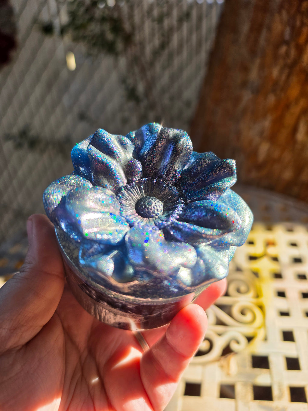 Side view of the Legacy Jar with sculpted floral lid in sunlight