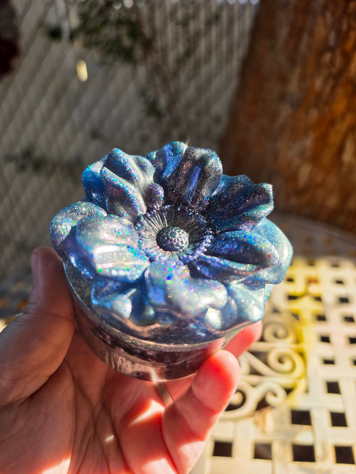 Side view of the Legacy Jar with sculpted floral lid in sunlight