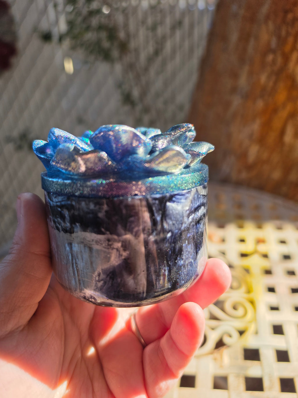 Close-up of the glittering flower-shaped lid on the Legacy Jar