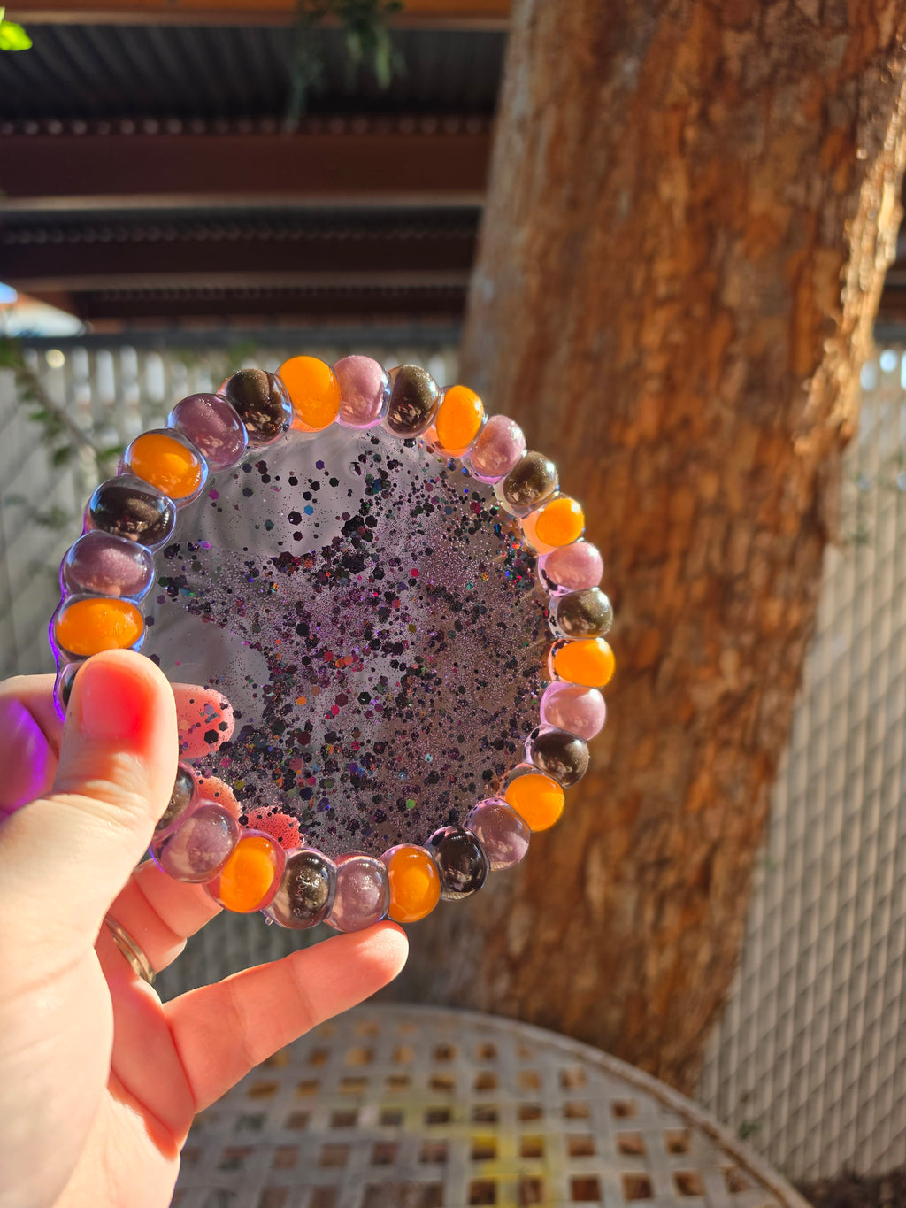 Halloween jelly bean resin trinket tray held in sunlight