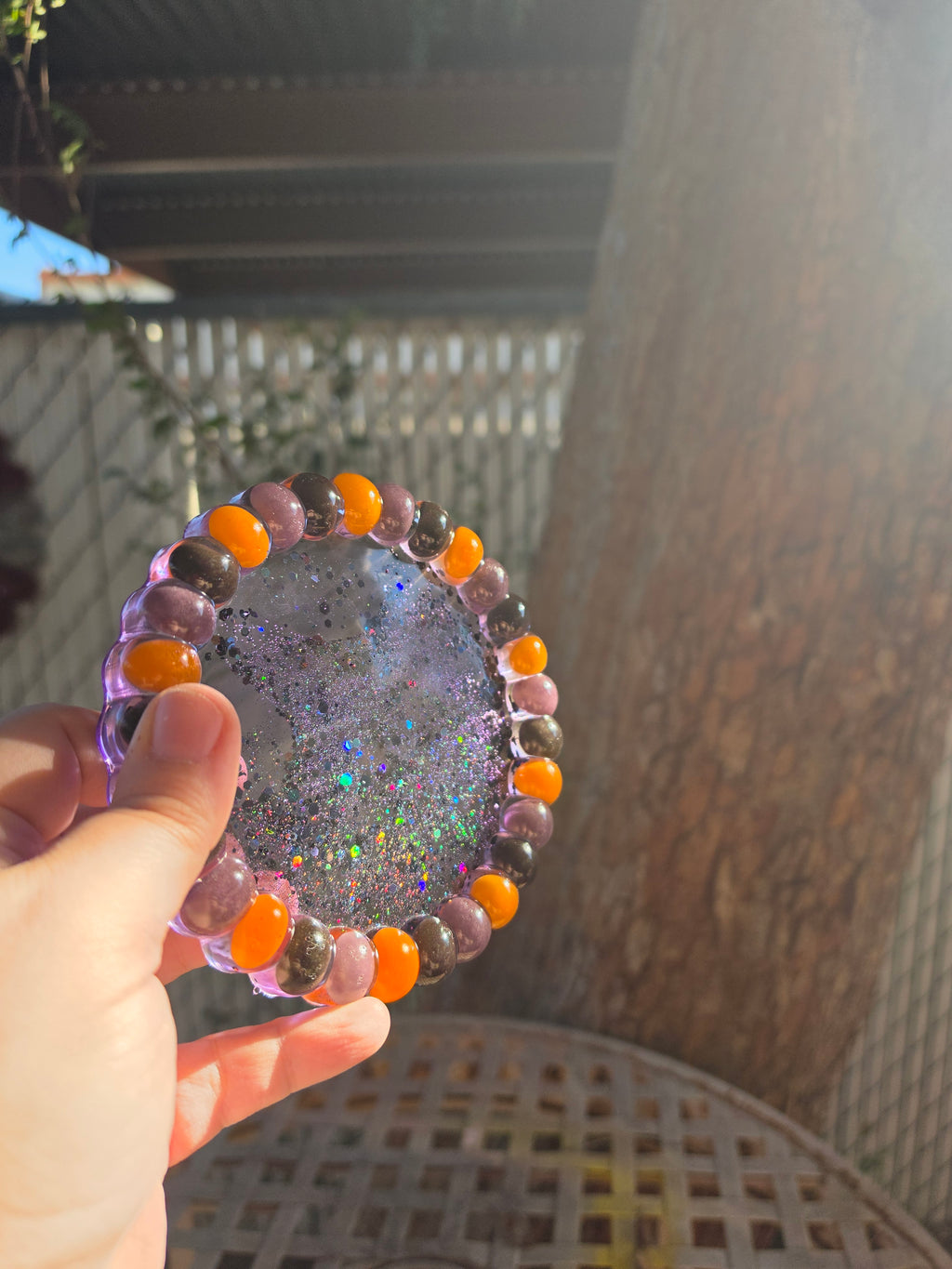 Sparkling resin trinket tray with Halloween jelly beans embedded in the rim